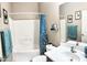 Well-lit bathroom with a shower-tub combo, white vanity, and blue accents throughout at 901 W Witt Ave, Queen Creek, AZ 85140