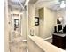 Hallway leading to bedrooms showing neutral walls and carpet; an office space is visible on the right at 901 W Witt Ave, Queen Creek, AZ 85140