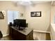 Well-lit office featuring a large desk setup, neutral carpet, and a ceiling fan for added comfort at 901 W Witt Ave, Queen Creek, AZ 85140