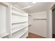 Spacious walk-in closet featuring ample shelving and rods for optimal storage at 16155 E Glenview Pl, Fountain Hills, AZ 85268