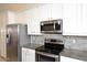 Close-up of the kitchen featuring stainless steel appliances and granite countertops at 16155 E Glenview Pl, Fountain Hills, AZ 85268