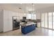 Kitchen featuring a blue island, stainless steel appliances, and white cabinetry at 16155 E Glenview Pl, Fountain Hills, AZ 85268