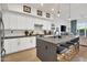 Modern kitchen with a large island, white cabinets, and gray countertops at 5151 N 13Th Pl # 4, Phoenix, AZ 85014