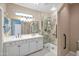 Modern bathroom with double vanity and glass shower, illuminated by overhead lighting at 13668 W Figueroa Dr, Sun City West, AZ 85375