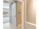 Bathroom doorway with white barn door offers a glimpse of a bathroom at 13668 W Figueroa Dr, Sun City West, AZ 85375