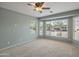 Inviting bedroom with ceiling fan and multiple windows for ample natural light at 13668 W Figueroa Dr, Sun City West, AZ 85375