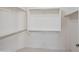 Walk-in closet with simple shelving system offers ample storage space at 13668 W Figueroa Dr, Sun City West, AZ 85375