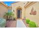 Inviting home entrance with landscaped walkway, decorative door, and unique wall art at 13668 W Figueroa Dr, Sun City West, AZ 85375