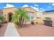 The home features a well-manicured yard and a cozy front patio with brick pavers at 13668 W Figueroa Dr, Sun City West, AZ 85375