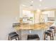 Open kitchen with granite countertops, breakfast bar, and modern white cabinetry at 13668 W Figueroa Dr, Sun City West, AZ 85375