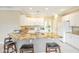 Bright kitchen features a granite island with seating, white cabinets, and stainless steel appliances at 13668 W Figueroa Dr, Sun City West, AZ 85375