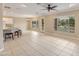 Spacious living area with tile floors, backyard access, and bright natural light at 13668 W Figueroa Dr, Sun City West, AZ 85375