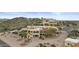 Aerial view of home with circular drive, porte-cochere and beautiful desert landscape at 6159 S Avenida Del Sol --, Gold Canyon, AZ 85118