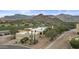 Aerial view of home with mountain views, desert landscaping, and solar panels at 6159 S Avenida Del Sol --, Gold Canyon, AZ 85118