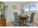 Cozy dining area with a round table, gray chairs, and a view to the sky through the window at 6159 S Avenida Del Sol --, Gold Canyon, AZ 85118
