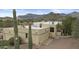 Spacious desert home with a flat roof, desert landscaping, and mountain views at 6159 S Avenida Del Sol --, Gold Canyon, AZ 85118