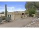 Single-story home with a two car garage featuring mature landscaping and gravel ground cover at 6159 S Avenida Del Sol --, Gold Canyon, AZ 85118