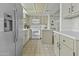 Well-lit kitchen featuring stainless steel appliances, white cabinets, and tile flooring at 6159 S Avenida Del Sol --, Gold Canyon, AZ 85118