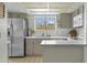 Bright kitchen with stainless steel appliances, tile flooring, and light-colored cabinets at 6159 S Avenida Del Sol --, Gold Canyon, AZ 85118