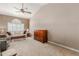 Spacious living room with vaulted ceiling, ceiling fan, and large window with shutters at 7752 W Mary Jane Ln, Peoria, AZ 85382