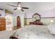 Main bedroom featuring vaulted ceiling, fan, and ensuite access at 7752 W Mary Jane Ln, Peoria, AZ 85382