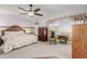 Main bedroom featuring vaulted ceiling, fan, and large window with curtains at 7752 W Mary Jane Ln, Peoria, AZ 85382