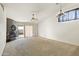 Living room with vaulted ceilings, a fireplace, and sliding glass doors at 8660 N 114Th Ave, Peoria, AZ 85345