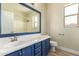 Bathroom featuring a blue vanity with white countertop and a shower/tub combo at 2156 E Aloe Pl, Chandler, AZ 85286