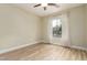 This bedroom features wood-look flooring and a bright window with curtains at 2156 E Aloe Pl, Chandler, AZ 85286
