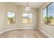 Cozy bedroom featuring hardwood floors, natural light from dual windows, and modern light fixture at 2156 E Aloe Pl, Chandler, AZ 85286