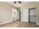 This bedroom features wood-look flooring, a closet with sliding doors, and ceiling fan at 2156 E Aloe Pl, Chandler, AZ 85286