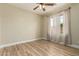 Neutral bedroom featuring vinyl flooring, a ceiling fan, light walls, and windows with curtains at 2156 E Aloe Pl, Chandler, AZ 85286