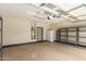Garage area featuring metal shelving units, water heater, and additional refrigerator at 2156 E Aloe Pl, Chandler, AZ 85286