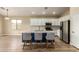 Bright kitchen features an island with barstool seating, stainless steel appliances, and white cabinetry at 2156 E Aloe Pl, Chandler, AZ 85286