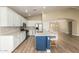 Modern kitchen features white cabinetry, stainless steel appliances, and a stylish center island with bar seating at 2156 E Aloe Pl, Chandler, AZ 85286