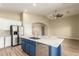 Kitchen showcases island with sink, modern stainless steel appliances and a view into adjacent rooms at 2156 E Aloe Pl, Chandler, AZ 85286