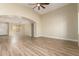 Bright and airy living room with hardwood flooring, an arched doorway, and a soaring ceiling with fan at 2156 E Aloe Pl, Chandler, AZ 85286