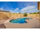 Backyard pool with rock waterfall features, complemented by a spacious patio area for entertaining at 2156 E Aloe Pl, Chandler, AZ 85286