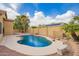 Inviting backyard pool with rock features and lush landscaping, perfect for relaxation and outdoor enjoyment at 2156 E Aloe Pl, Chandler, AZ 85286