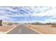 Street view of several homes with desert landscaping and mountainous views in the background on a clear day at 10298 W Morgan Ct, Casa Grande, AZ 85194