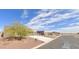 Street view of a home showing the desert landscape with a large driveway and multiple garage spaces at 10298 W Morgan Ct, Casa Grande, AZ 85194