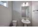 Small bathroom with pedestal sink and toilet at 2646 E Bluff Spring Ave, Apache Junction, AZ 85119
