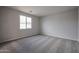 Spacious bedroom with neutral carpeting and large window at 2646 E Bluff Spring Ave, Apache Junction, AZ 85119