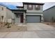 Two-story house with gray siding, two-car garage, and small front yard at 2646 E Bluff Spring Ave, Apache Junction, AZ 85119
