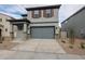 Two-story house with gray siding, two-car garage, and small front yard at 2646 E Bluff Spring Ave, Apache Junction, AZ 85119