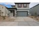 Two-story house with gray siding, brown accents, and a two-car garage at 2646 E Bluff Spring Ave, Apache Junction, AZ 85119
