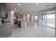 Open-concept kitchen with gray cabinets, granite island, and access to backyard at 2646 E Bluff Spring Ave, Apache Junction, AZ 85119