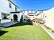 Spacious backyard featuring artificial turf, patio with seating, and privacy walls, ideal for outdoor relaxation at 6437 N 17 St, Phoenix, AZ 85016