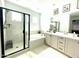 Modern bathroom featuring dual sinks, a soaking tub, and a glass-enclosed shower at 6437 N 17 St, Phoenix, AZ 85016