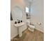 Bathroom with a sink and mirror. The bathroom is small with a toilet next to the sink at 6437 N 17 St, Phoenix, AZ 85016